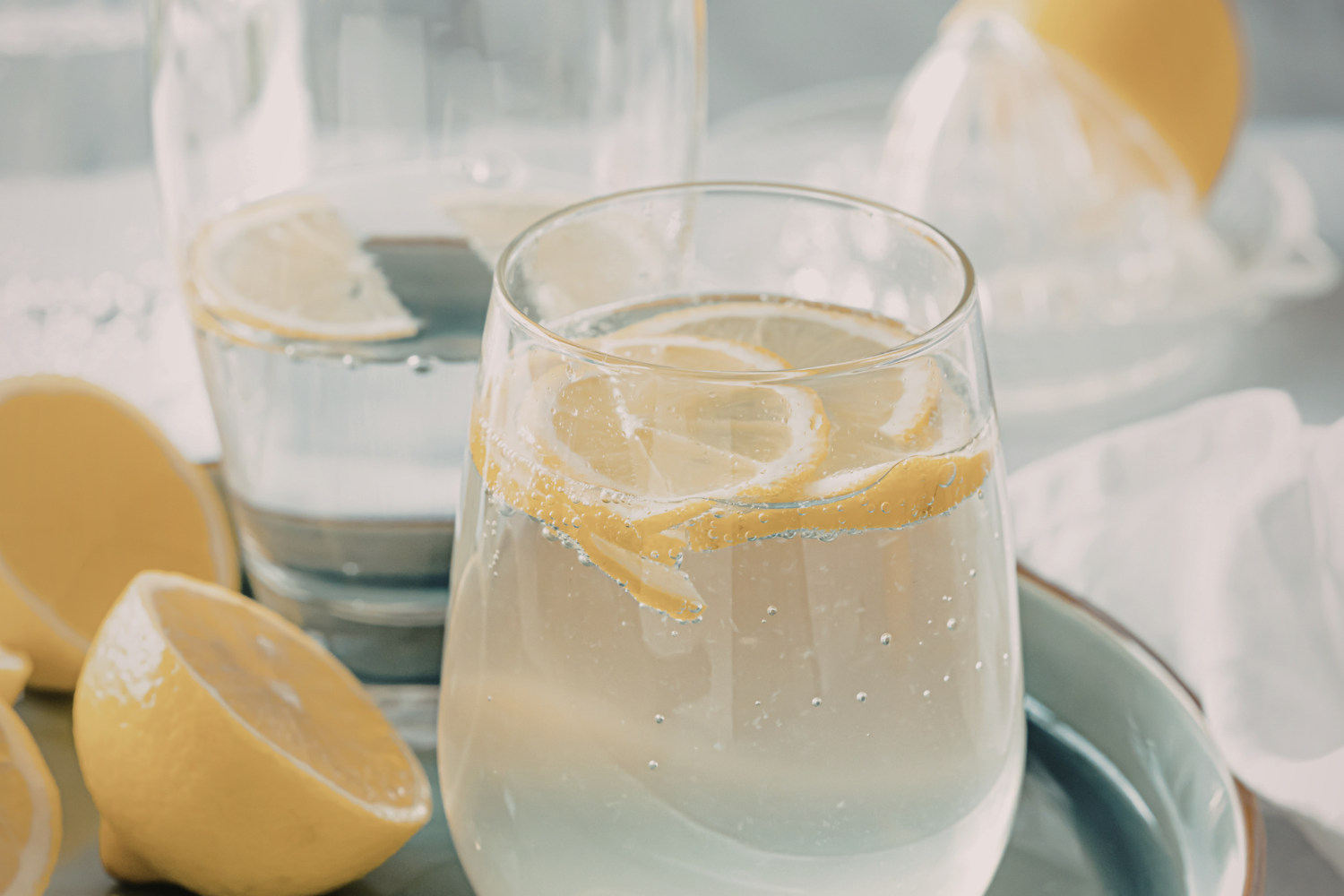 Glass of electrolyte drink with lemon slices.