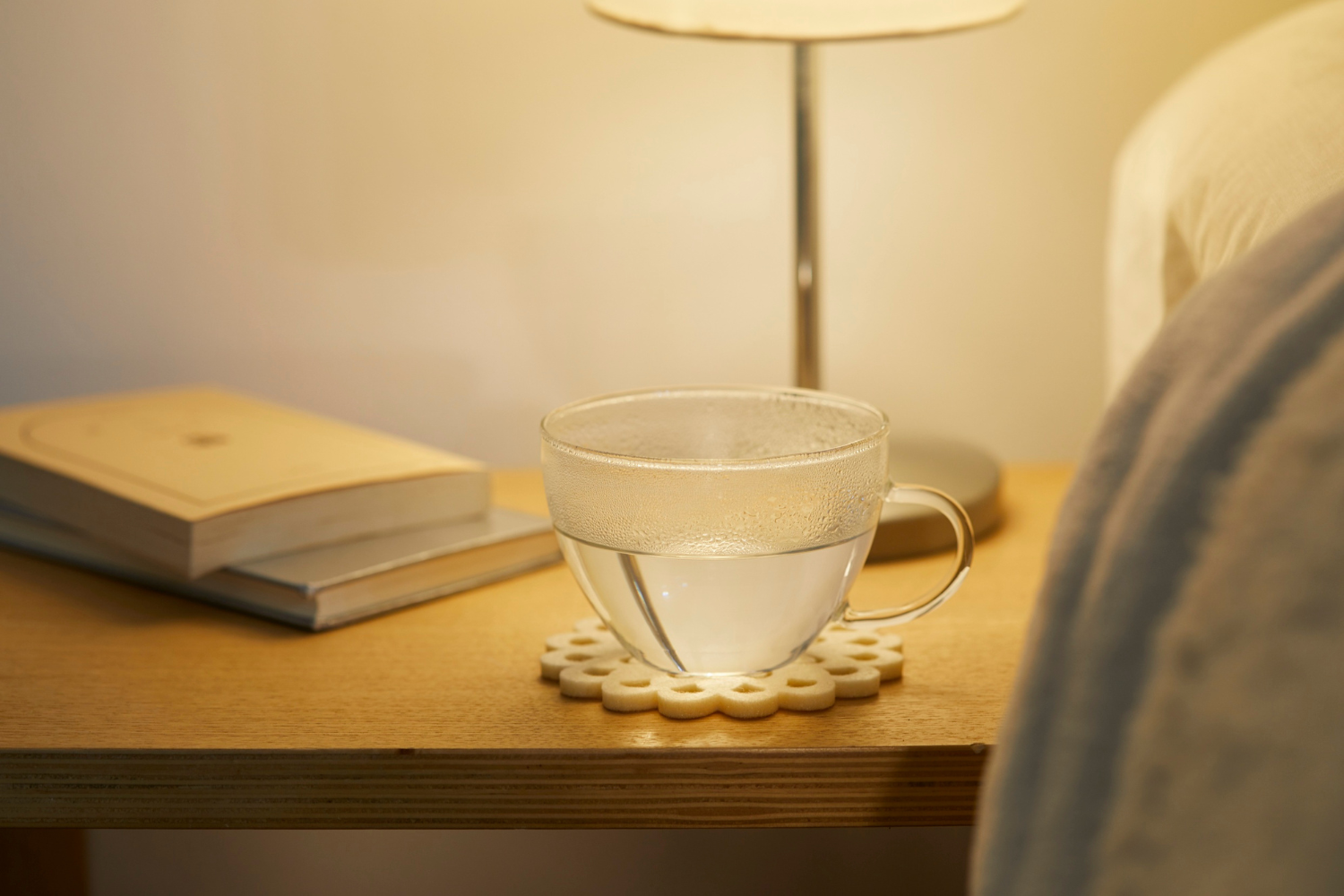 Glass of electrolyte water on nightstand