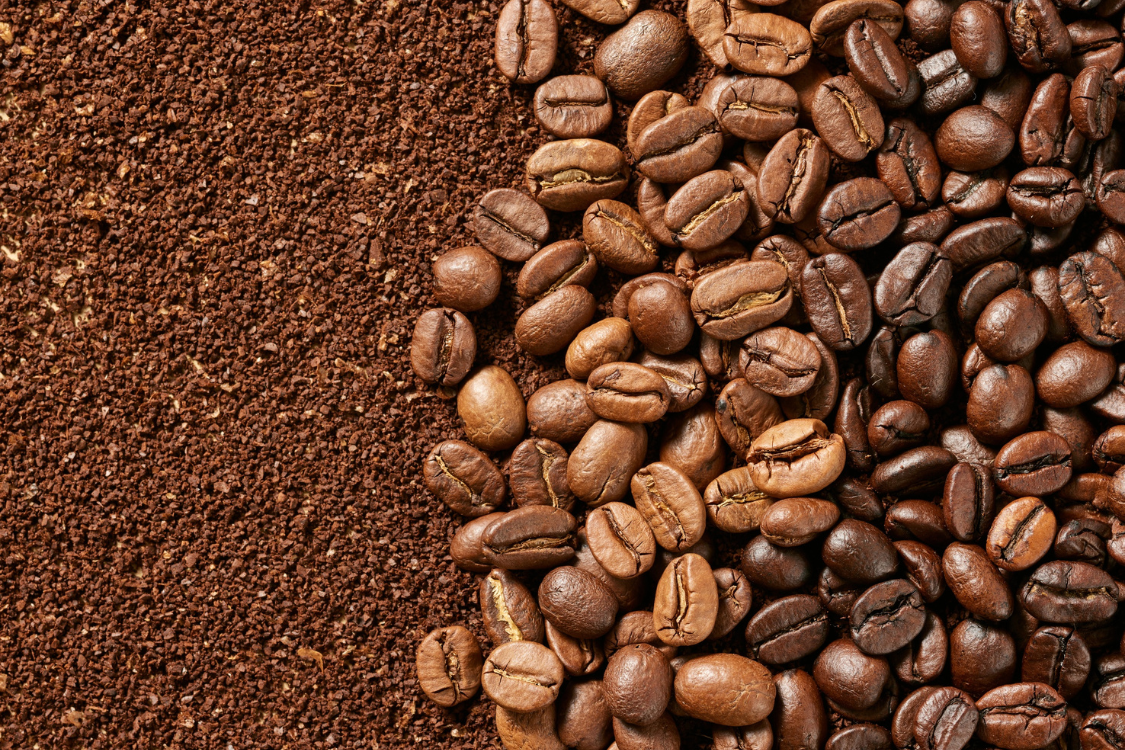 A close-up showing whole coffee beans next to finely ground coffee, representing the natural source of caffeine and energy, contrasted with electrolytes.
