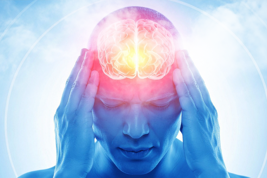 Conceptual image of a man holding his head with a glowing, stylized brain, illustrating the impact of dehydration on brain function and mental processes