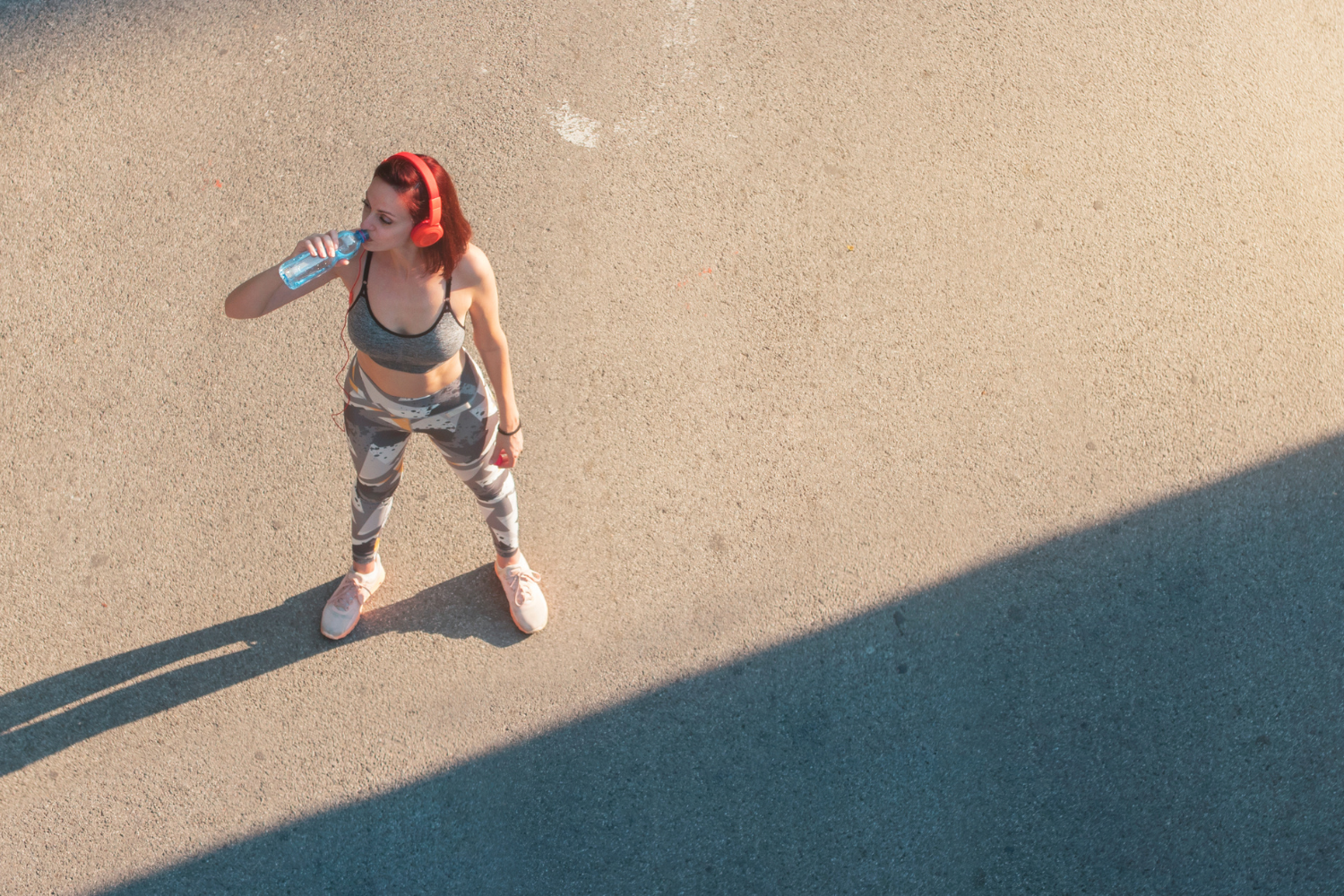 Athletic woman drinking water.