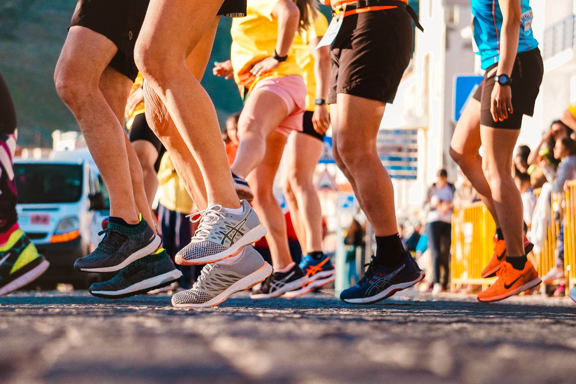 Runners at a start line preparing hydration, electrolytes before or after running.