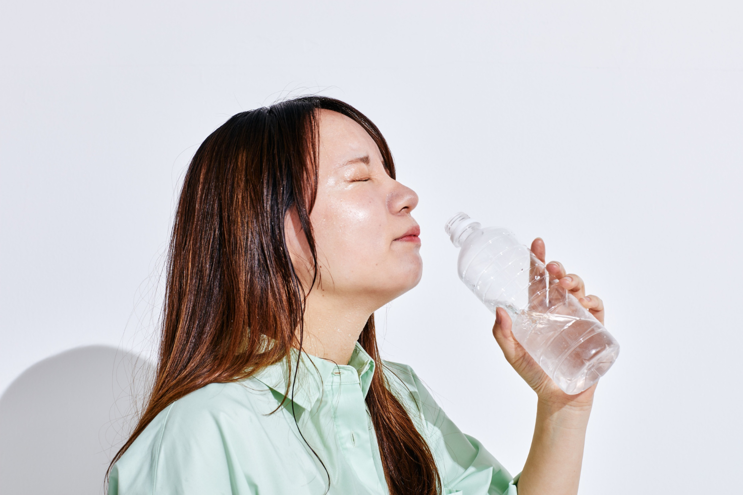 Woman drinking water while feeling thirsty